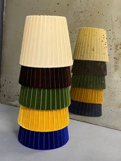 a group of different colored lamps sitting on top of a table next to each other