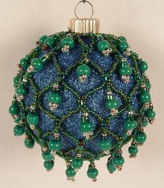 a blue ornament with green beads on it