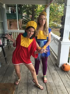 two women in costumes standing on a porch