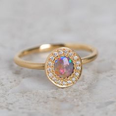 Our Pebble collection of raw, rough, beaten metals set with precious gems. Perfectly imperfect and all one of a kind. Our Black Opal and Diamond Pebble Ring is set with a black opal, surrounded by a halo of G/VS brilliant cut diamonds. Black opal measures 5mm. Total diamond weight 0.06ct. Top of ring measures 10 x 9mm. Band width 1.6mm. Metal weight 3.5g approx. Pictured with a matte finish. For a high shine finish please leave a note at checkout. Please note, we will match the opal as close to Pebble Collection, Pebble Ring, Jeweled Bag, Opal Band, J Us, Instagram Icons, Precious Gems, Perfectly Imperfect, Black Opal