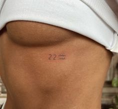 a woman's lower back with the number 22 on her left side, and two numbers