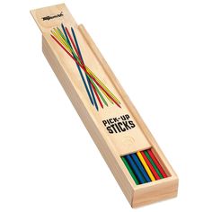 a wooden box filled with colored pencils on top of a white background and the words pick - up sticks in it