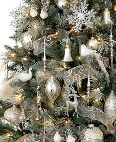 a christmas tree decorated with silver and white ornaments