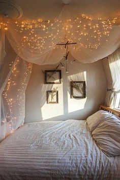 a bedroom with lights strung from the ceiling