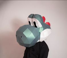 a person wearing a paper mask with an origami dragon on it's head