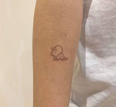 a small tattoo on the arm of a woman's left arm, with a rhino