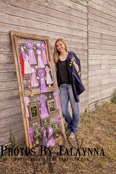 a woman standing next to a wooden sign