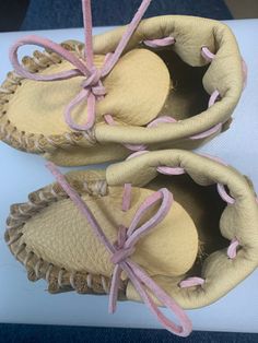 Leather moccasins for 6-9 month old. Available with pink or blue lacing. Leather Non-slip Slip-on Moccasins, Leather Slip-on Non-slip Moccasins, Non-slip Brown Leather Moccasins, Suede Moccasins With Soft Closed Toe, Brown Leather Non-slip Moccasins, Suede Moccasins With Soft Sole And Closed Toe, Closed Toe Suede Moccasins With Soft Sole, Pink Casual Moccasins With Round Toe, Casual Pink Moccasins With Round Toe