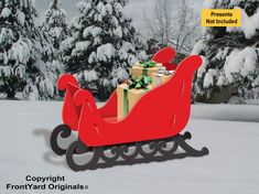 a red sleigh with presents on it in the snow