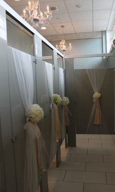 the bathroom stall is decorated with white flowers