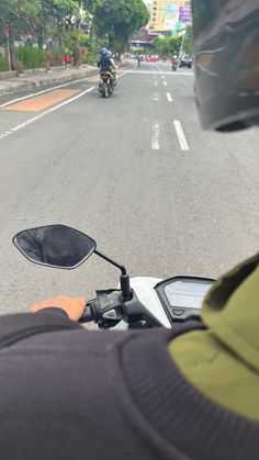 a person riding a motorcycle down a street