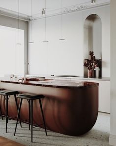 a kitchen with an island and stools in it