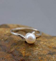 Devika CW - $399.00, via Etsy. Delicate Round Jewelry With Tension Setting, Classic Pearl Promise Ring, Delicate White Gold Formal Rings, Delicate White Gold Rings For Formal Occasions, Silver Wedding Ring With Tension Setting, Elegant Pearl White Promise Ring, Classic White Open Band Rings, Silver Wedding Jewelry With Tension Setting, Minimalist Polished Pearl Ring For Anniversary