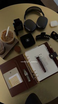 the contents of an office desk with headphones, notebooks and other personal items