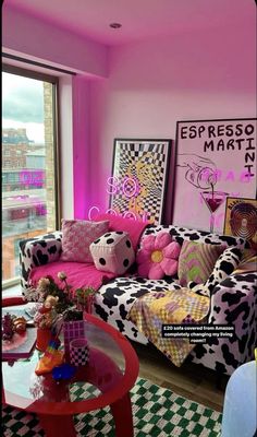 a living room with pink walls and black and white checkered rugs on the floor