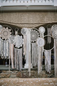 some white doily hanging from the side of a building