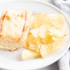 a sandwich and chips on a white plate