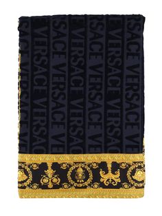 a black and gold scarf with the words versa versa on it's side, in front of a white background