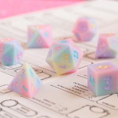 a close up of dices on a table with numbers and symbols painted on them