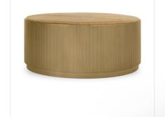 a round wooden table sitting on top of a white floor