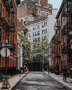 an empty city street lined with tall buildings