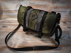 a green bag sitting on top of a wooden floor