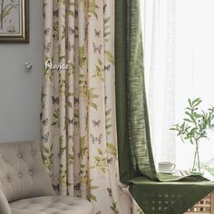 the curtains in this living room are green and white with butterflies on them, along with a potted plant