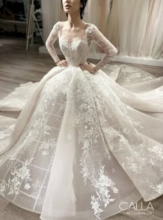 a woman in a white wedding dress with flowers on it