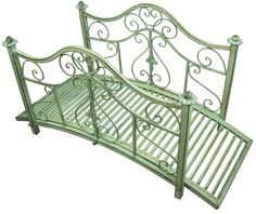 a green metal bed frame sitting on top of a white floor