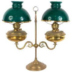 two green and gold lamps sitting on top of each other