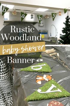 a baby shower banner made out of plastic and grass with the words rustic woodland baby shower banner on it