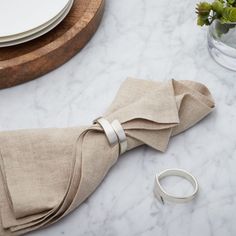 the napkins are tied together on the table