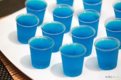 blue cups sitting on top of a white plate