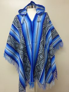 "BLUE AND BLACK HOODED SHAMAN AGUAYO PONCHO This poncho is handwoven in the traditional Andean method \"Aguayo\" This poncho will fit people size ranging from medium to large. AGUAYO: It is a naturally dyed blend of alpaca, llama, and sheep wool; handwoven in the Andean village of Peru called Paucartambo by the Q'eros community. Country: Perú Culture: Quechua Material: Alpacryl ( Alpaca and acrylic) Measurement: 70 X 46 ( including fringe)" Traditional Blue One-size Poncho, Traditional Blue Poncho, One Size Blue Poncho For Festivals, Blue One-size Poncho For Festivals, Blue One Size Poncho For Festival, Traditional One Size Hooded Poncho, Blue Winter Festival Poncho, Peru Culture, Fit People