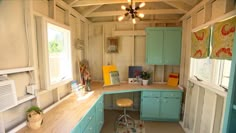 a kitchen with blue cabinets and counter tops in a small space that is well lit