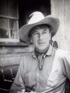 black and white photograph of a man wearing a cowboy hat