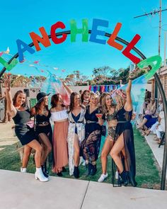 a group of young women standing next to each other under an arch with the word gangiel on it