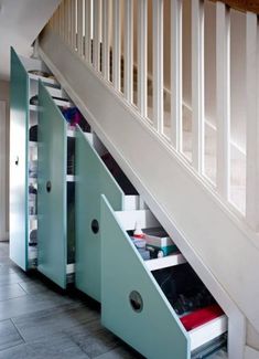 an under stair storage unit with drawers underneath the stairs