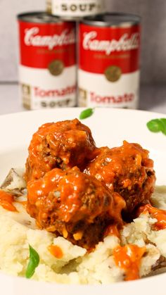 meatballs and mashed potatoes on a plate with two cans of campbell's soup