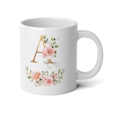 a white coffee mug with pink flowers and the letter a in gold foil on it