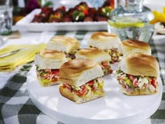 several sandwiches are arranged on a white plate