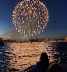 fireworks are lit up in the sky over water