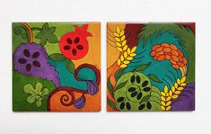 two square tiles with flowers and plants painted on them