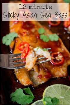 a close up of food on a fork with limes and cilantro in the background