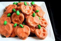 a white plate topped with candy shaped like pumpkins