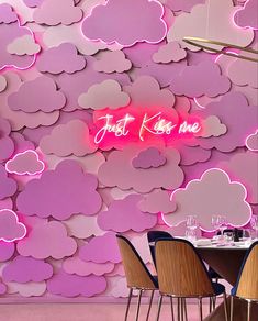 a restaurant with pink clouds painted on the wall