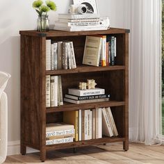 a bookshelf filled with lots of books next to a window