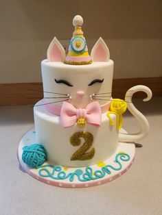 a birthday cake with a cat on top