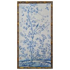 a blue and white wall hanging with birds on the tree in front of it's branches