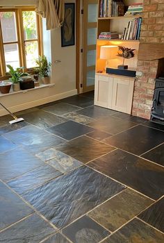 a living room with black slate tile flooring